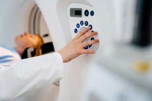 Medical professional operating advanced imaging machine for diagnosis