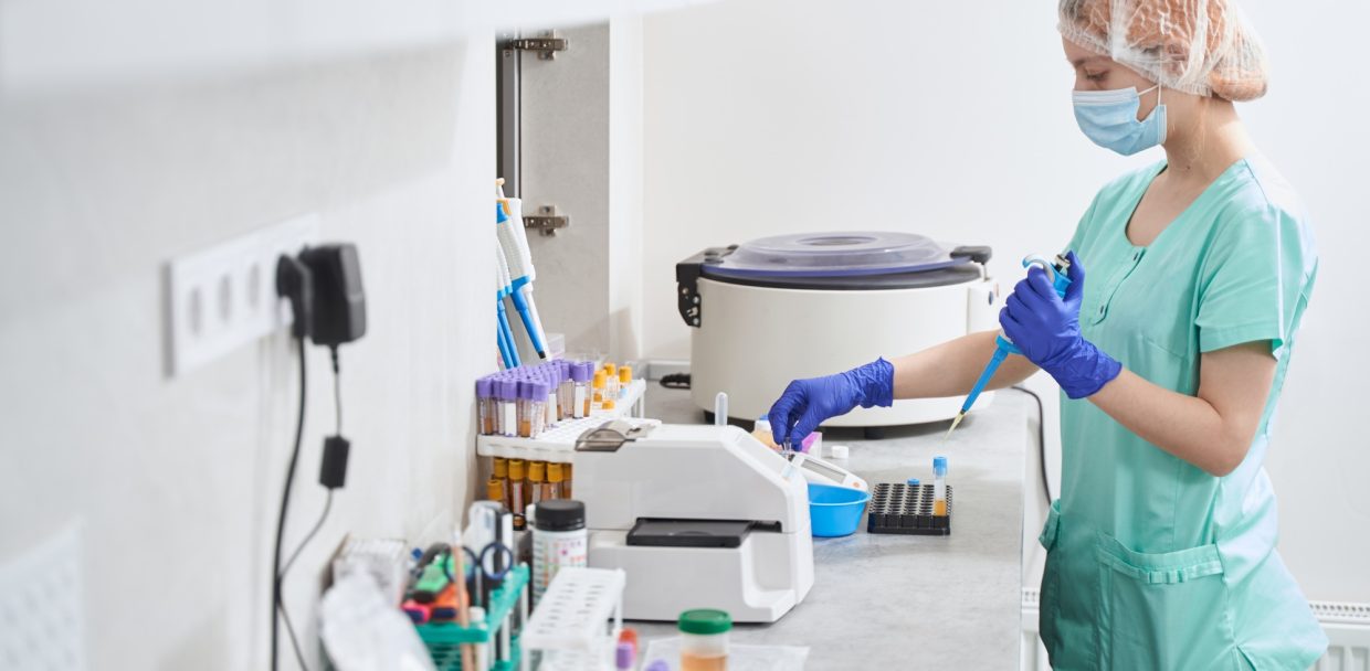 Female in medical suit working in laboratory